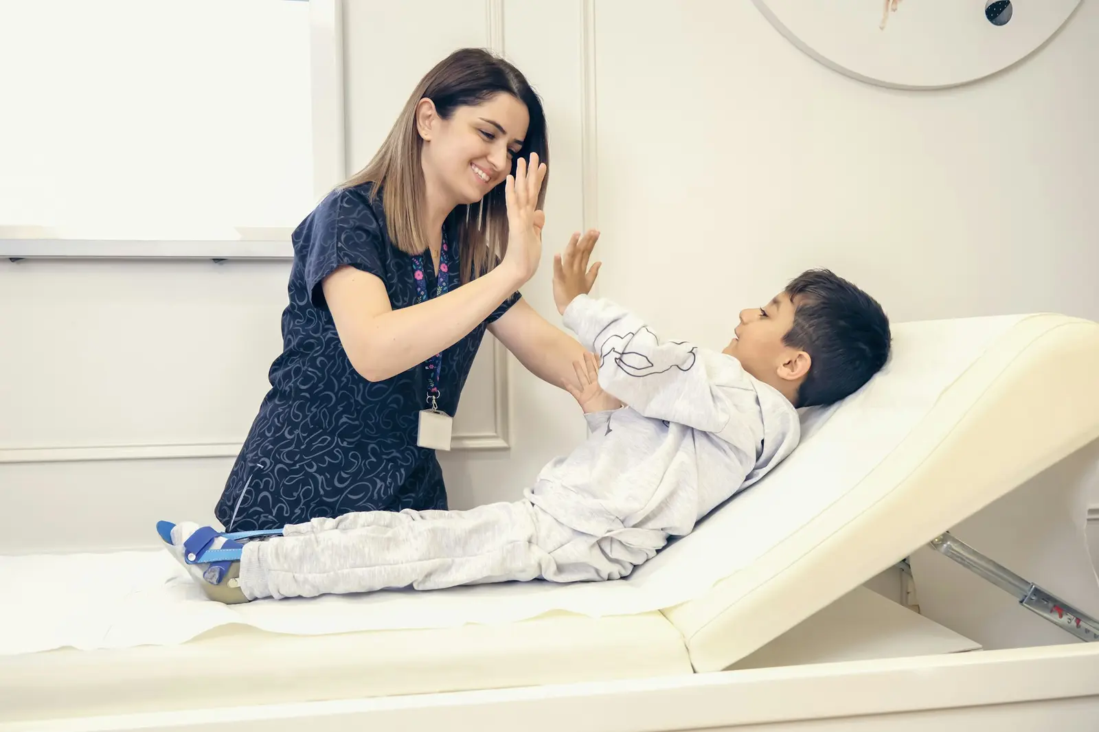 Bác sĩ khám và động viên bé trong buổi kiểm tra tai tại phòng khám